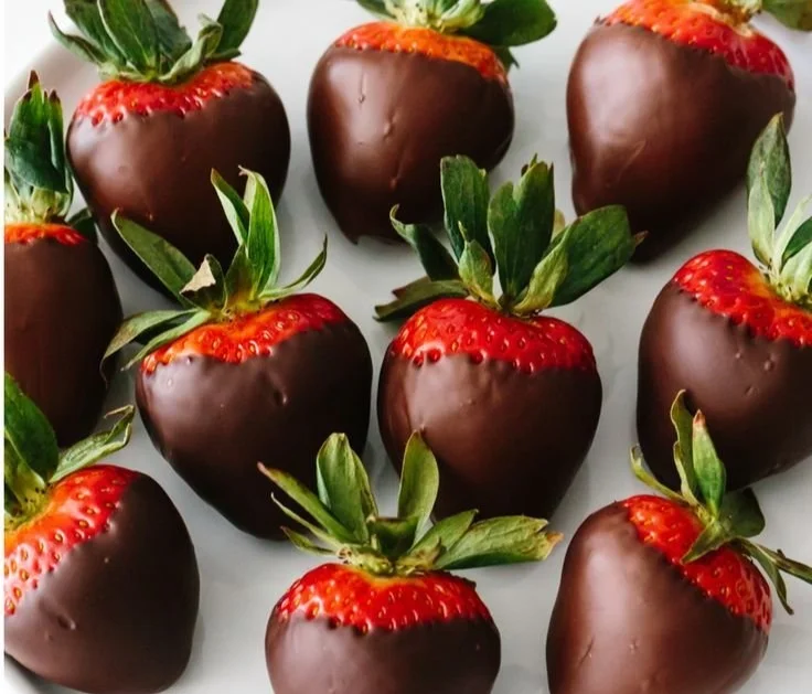 A plate of chocolate covered strawberries ready for serving
