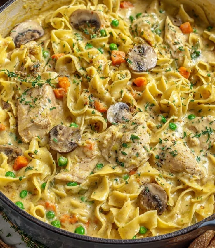 Creamy chicken pot pie one pot pasta served in a bowl with parsley garnish