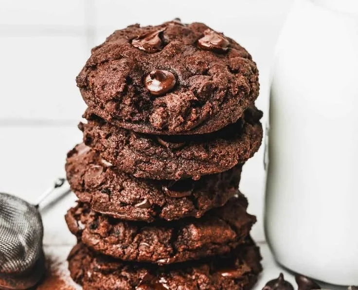 Delicious double chocolate chip cookies stacked on a plate