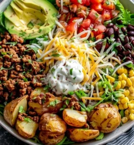 Loaded Potato Taco Bowl with toppings in a colorful dish