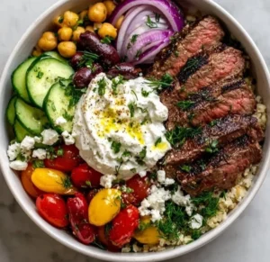Delicious Mediterranean Steak Bowl filled with grilled steak, veggies, and sauce