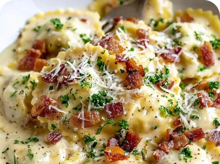 Delicious plate of Olive Garden Ravioli Carbonara topped with creamy sauce and herbs