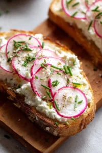 Savory cottage cheese and radish toast garnished with fresh herbs
