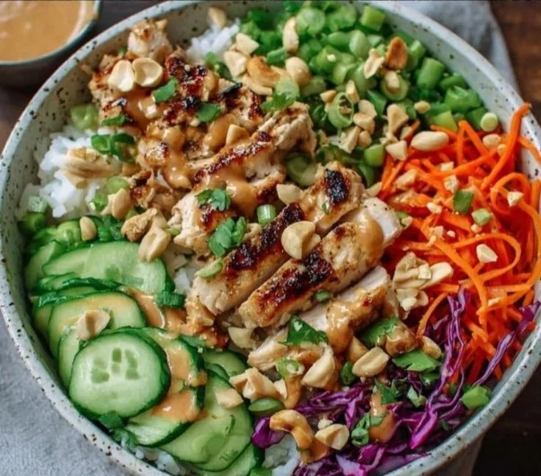 Delicious Thai-Inspired Peanut Chicken Bowl with vibrant vegetables and creamy sauce