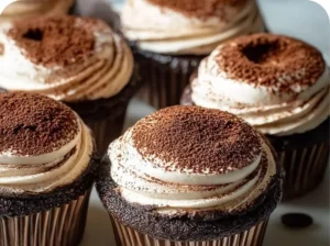 Delicious tiramisu cupcakes with coffee frosting and cocoa powder.