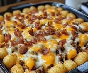 Bacon cheeseburger tater tot casserole topped with melted cheese and crispy bacon