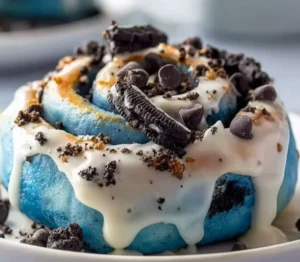 Delicious blue-iced cinnamon rolls with cookie crumbles on top