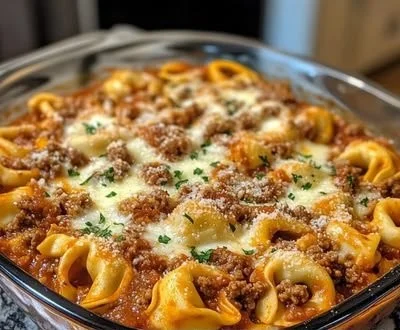 Cheesy Beef Tortellini Bake topped with melted cheese and herbs