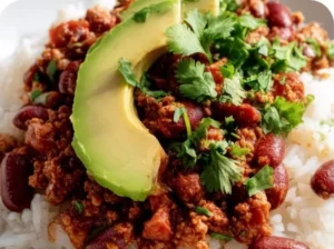 Chili Taco Rice Bowls topped with fresh ingredients and served in a bowl