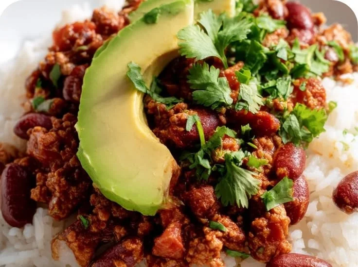 Chili Taco Rice Bowls topped with fresh ingredients and served in a bowl