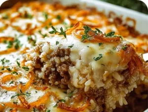 Delicious French onion ground beef and rice casserole served in a baking dish.