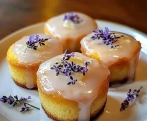 Lemon Mini Cakes topped with Lavender Glaze on a white plate