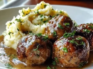 Salisbury steak meatballs served with creamy garlic herb mashed potatoes