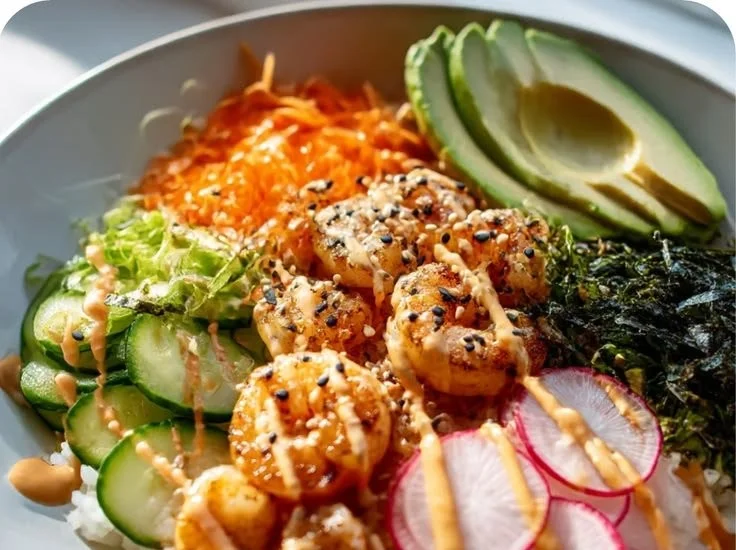 Shrimp rice bowls served with a spicy mayo drizzle and colorful vegetables