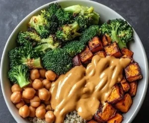 Vibrant Thai Peanut Buddha Bowl with Sweet Potatoes and fresh vegetables