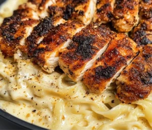 Creamy Blackened Cajun Chicken Alfredo served in a bowl with herbs