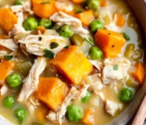 Creamy Crustless Chicken Pot Pie Soup served in a bowl with fresh herbs