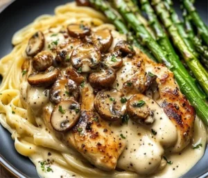 Creamy garlic mushroom chicken Alfredo with asparagus served in a bowl