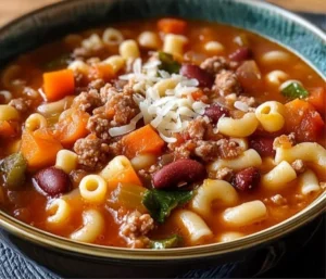 Delicious Olive Garden Pasta e Fagioli copycat recipe in a bowl with ingredients.