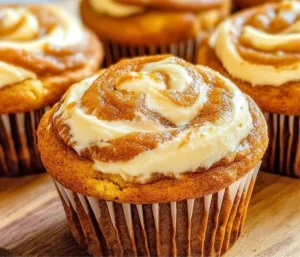 Pumpkin Cream Cheese Swirl Muffins on a rustic table
